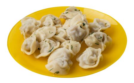 dumplings on a yellow plate isolated on white backgroundの写真素材