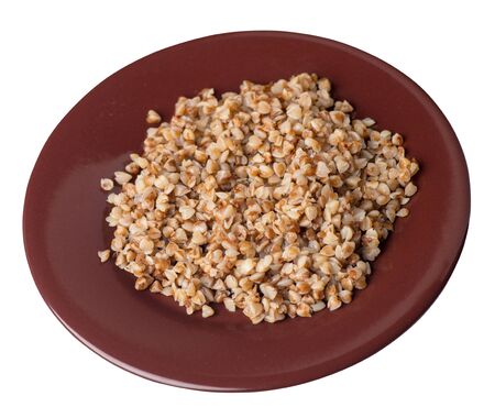 buckwheat in a brown  plate isolated on white background. buckwheat top side  view. Healthy food. veretian foodの写真素材