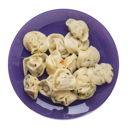 dumplings on a purple plate isolated on white background .boiled dumplings.meat dumplings top view .pelmeni with dillの写真素材