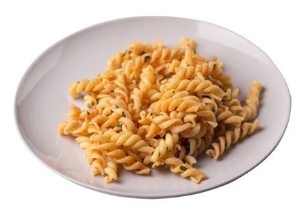 pasta on a light gray  plate isolated on white background. pasta in tomato sauce with dill. pasta top side viewの写真素材