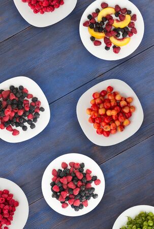 fruits on a plate. vegetarian food on wooden background. vegan food top view .の写真素材