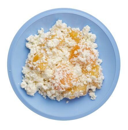 cottage cheese with peaches on a light blue  plate isolated on white background. cottage cheese top view. healthy breakfastの写真素材