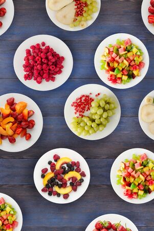 Fruit diet. Fruits on a plate on a wooden background. Healthy food top view.の写真素材