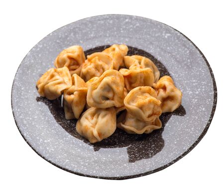 dumplings on a  brown with a marble crumb plate isolated on white background. dumplings in tomato sauce. dumplings top side viewの写真素材