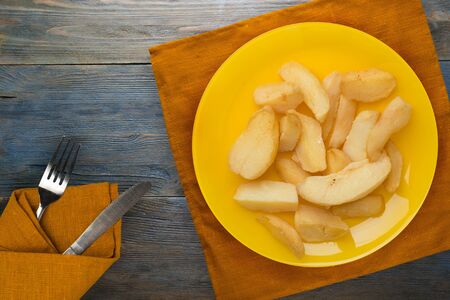 french fries on a yellow plate on a blue wooden background.fast food top view.junk foodの写真素材