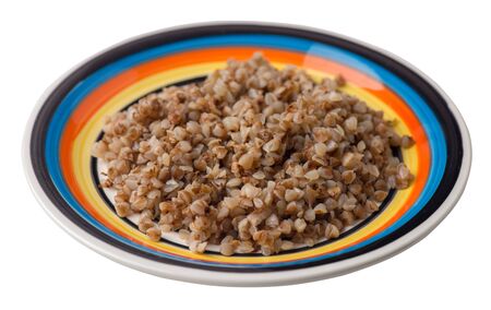 buckwheat in a multicolored plate isolated on white background. buckwheat top side view. Healthy food. veretian foodの写真素材