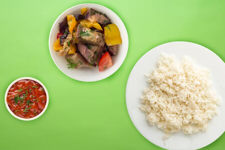 white rice on a white  plate. rice with vegetable salad  on a lime  background top view .asian foodの写真素材