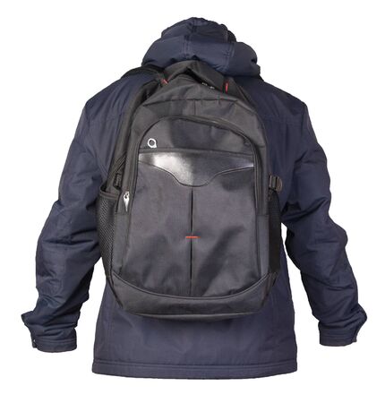black backpack dressed in a blue jacket isolated on a white background. rear view of a backpack and jacketの写真素材