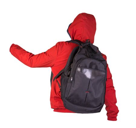 black backpack dressed in a red jacket isolated on a white background. rear view of a backpack and jacketの写真素材
