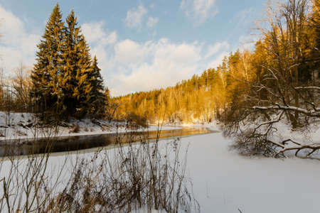 River extending in the winter forest. Beautiful nature in winterの写真素材