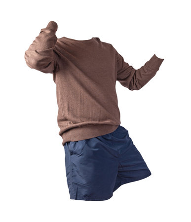 knitted brown sweater and dark blue shorts isolated on white background. fashionable clothes for every dayの写真素材