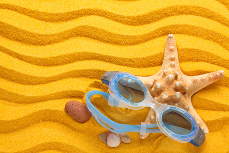 Blue swimming goggles  and starfishes の写真素材