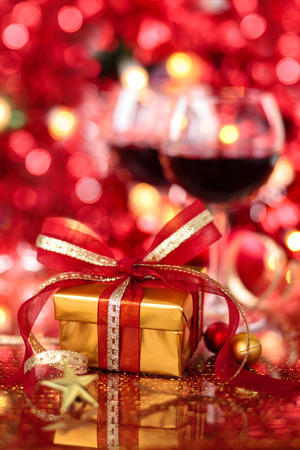 Gift and wine for holidays against blured lights.の写真素材