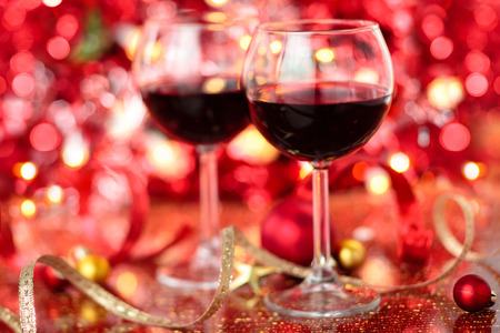 Gift and wine for holidays against blurred lightsの写真素材