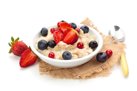 Oatmeal  and fresh fruits isolated on white background.の写真素材