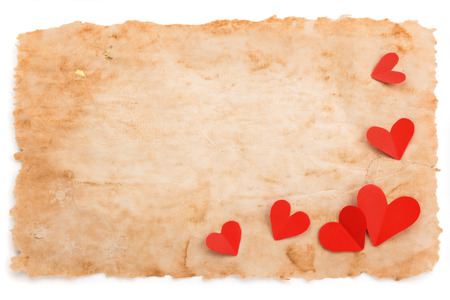 Ancient paper and paper hearts. Isolated on white bakcground.の写真素材