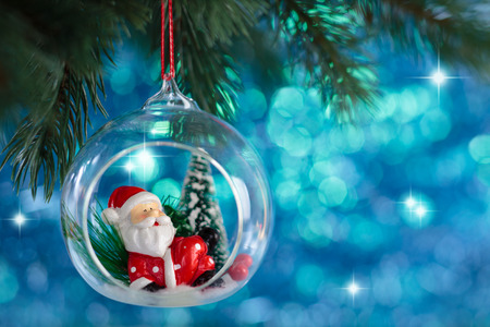 Christmas ball with Santa Claus hanging on tree.の写真素材