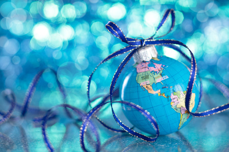 Christmas Globe in blurred blue lights background.の写真素材