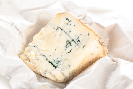 Fresh Italian gorgonzola on white crumpled paper.の写真素材
