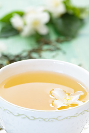 Cup of green tea with flowers of  jasmine.の写真素材