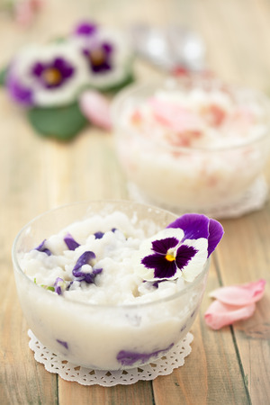 Risoto prepared with edible flowers : violet and pink rose.の写真素材