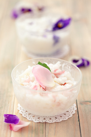 Risoto prepared with edible flowers : violet and pink rose.の写真素材