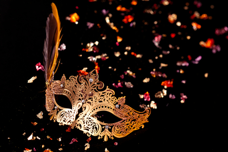 Gold carnival mask on black background.の写真素材