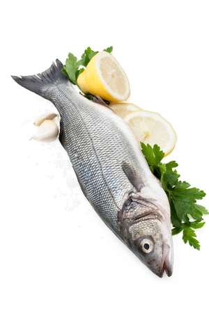 Fresh fish with lemon and parsley. Isolated on white background.の写真素材