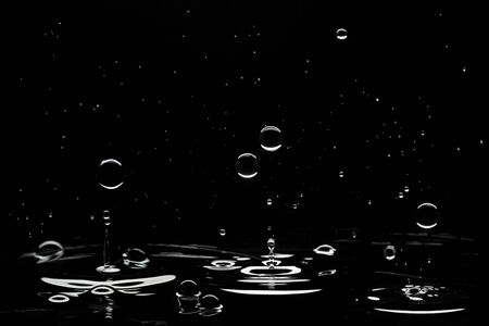 Brilliant drops transparent water on black background.の写真素材