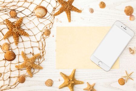 Summer time concept with sea shells and starfish on a white wooden background.の写真素材