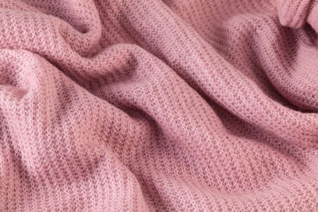 Detail of pink warm fabric texture material background.の写真素材