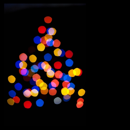 Abstract background - blurred colorful circles bokeh of Christmaslight in the form of a Christmas...