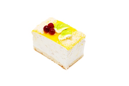 Souffle cake, decorated with coconut, cream and cranberries. Isolated on white backgroundの写真素材