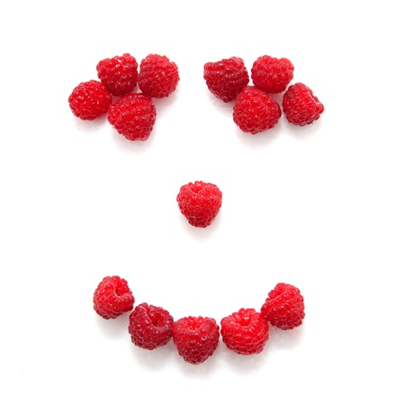Smile composed of raspberries   Isolated on white backgroundの写真素材