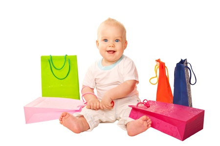 Baby shopping  Happy smiling kid sitting with shopping bags  Isolated on white backgroundの写真素材