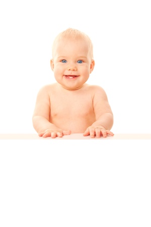 Happy smiling baby holding white board with copy space for text   Isolated on white background の写真素材