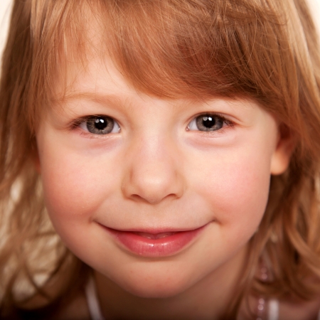 Beautiful funny red haired little girl.の写真素材
