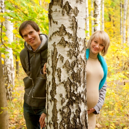 Young couple in love in the autumn forest near the birch  の写真素材