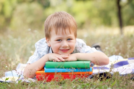 Funny boy and a book outdoors  Back to school  Summer holiday の写真素材