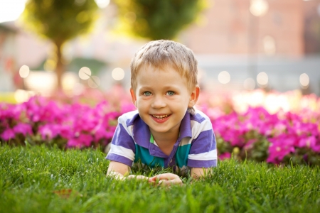 Portrait of adorable little boy among the flowers. Summer holiday.の写真素材