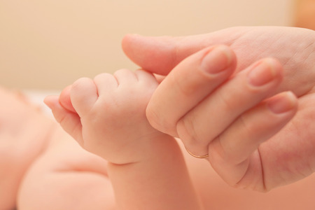 Baby and mothers hands. Family and love concept.の写真素材