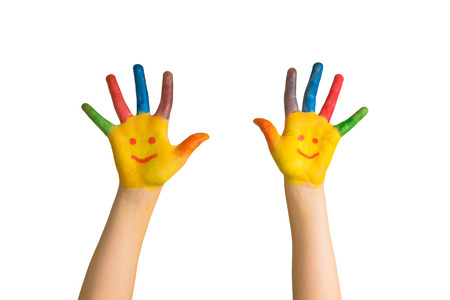 Children's painted hands with smiling faces. Kids hands and palms painted smiling faces. Happy children draw smileys. Happiness, joy, education, creative, school concept. Isolated on white background.の写真素材