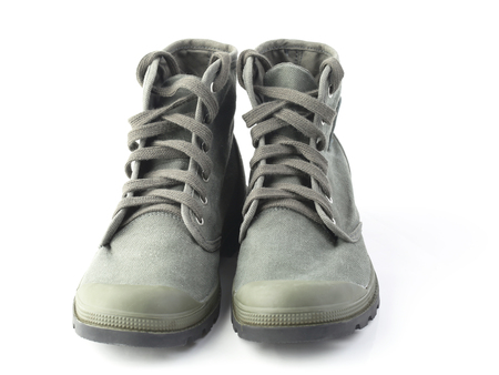 Green military style sneakers isolated on whiteの写真素材