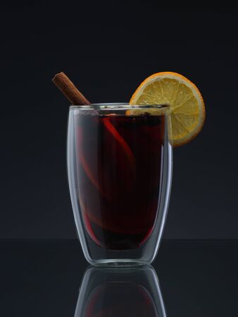 Glass with mulled wine on gradient grey backgroundの写真素材