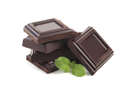 Dark chocolate with leaves isolated on whiteの写真素材