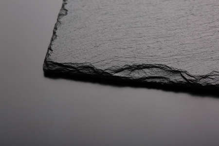 Black slate stone on black board. Background or texture. Top viewの写真素材