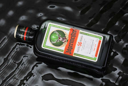 Kropyvnytskyi, Ukraine - 17 November 2020: Bottle of liquerer Jagermeister over black water waves backgroundのeditorial素材