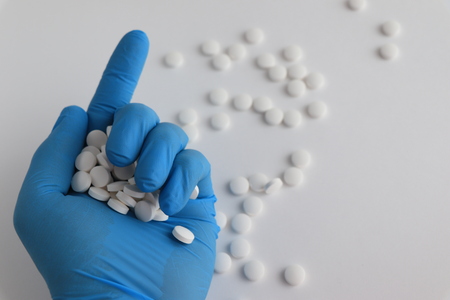 Man with red and white pills in palm