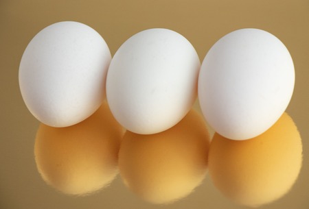 The eggs are white on a Golden background.の写真素材
