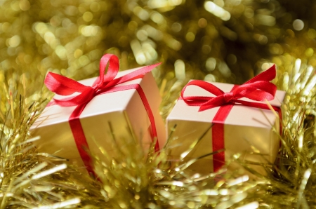 Gift boxes with red ribbon on abstract holiday backgroundの写真素材